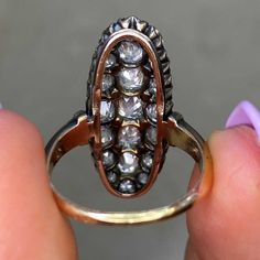 An original Victorian era navette ring set with a cluster of old mine cut diamonds. The diamonds have a total approximate weight of 3.50 carats, I-J color and SI1 clarity overall. The elongated mounting is silver on 18k yellow gold, and bears French import marks. This ring is antique and was handcrafted circa 1870.
The measurements of this ring are approximately 1.00 inch x 0.40 inch. An original Victorian ring this elongated is rare.
This ring can be resized to any finger size at no extra cost. Antique Marquise Cut Cluster Ring For Formal Occasions, Victorian Marquise Ring For Anniversary, Antique Marquise Diamond Ring, Victorian Marquise Diamond Ring For Formal Occasions, Antique Marquise Cluster Ring For Wedding, Antique Oval Diamond Ring, Antique Cluster Diamond Ring With Accents, Victorian Diamond White Ring With 17 Jewels, Antique Cluster Rings With Diamond Accents