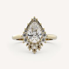 an engagement ring with a pear shaped diamond surrounded by small round diamonds and yellow gold accents