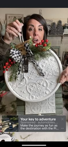 a woman holding up a plate with decorations on it