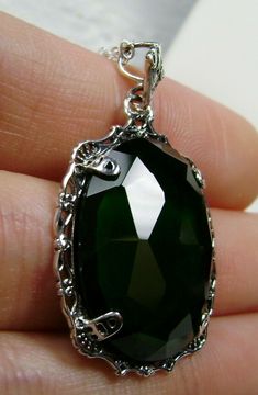 "Simulated Green Emerald Pendant Bubble Design#P10 Custom Made Inspired by Victorian era designs, I now offer this lovely Antique reproduction in sterling silver. The 22ct faceted simulated green emerald gemstone is 24mm long (15/16th\") and 18mm in width (3/4th\"). The entire pendant is 1.5\" long and 7/8\" wide. The chain (if chosen) is between 18-20 inches in length and is marked 925 as well. Notice the beautiful craftsmanship of the Victorian filigree setting. This pendant necklace is a true Victorian Filigree, Mystic Fire Topaz, Filigree Pendant Necklace, Bubble Design, Filigree Pendant, Emerald Pendant, Cameo Pendant, Sterling Silver Filigree, Mystic Topaz