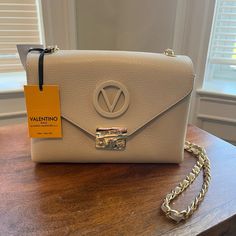 Truly The Perfect Size Bag, Not Too Big Not Too Small With Great Compartments. Never Used Nwt Valentino Bag. The Perfect Touches Of Gold Detailing On A Beautiful Nude. Simple And Classic, Love This Bag! Designer Beige Flap Bag With Gold-tone Hardware, High-end White Flap Bag For Evening, White High-end Evening Flap Bag, High-end White Evening Flap Bag, Luxury Beige Pouch Flap Bag, Designer Pouch Flap Bag With Gold-tone Hardware, Designer Beige Flap Bag For Evening, Designer Crossbody Bag With Chain Strap, Elegant Clutch Shoulder Bag With Branded Hardware