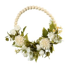 a white necklace with flowers and greenery on the front is hanging from a beaded cord