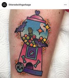 a tattoo with a gummy machine and skulls on it