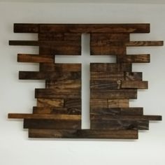 a cross made out of wooden planks on the wall