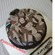 there is a cake that looks like it has buttons on the shirt and tie design