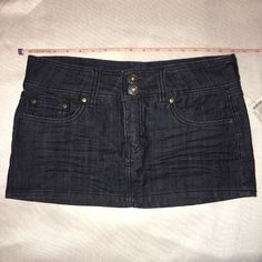 Dark Wash. Size 9. Zipper Fly. Front And Back Pockets. New W/Tags. Waist/Hip 32" Length 11" Fitted Mini Denim Skirt With Button Zip Fly, Trendy Fitted Dark Wash Skort, Mid-rise Fitted Skort With Pockets, High Waist Fitted Dark Wash Skort, Fitted Dark Wash Cotton Skort, Fitted High Waist Dark Wash Skort, Stretch Dark Wash Mini Skirt, Fitted Dark Wash Bottoms In Mini Length, Fitted Dark Wash Mini Bottoms