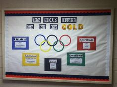 a bulletin board with olympic symbols on it