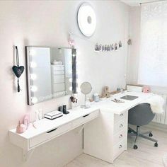 a white desk topped with a mirror next to a window