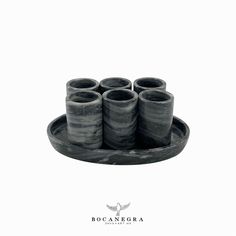 six black marble cups on a tray with the words bocanebra written in white