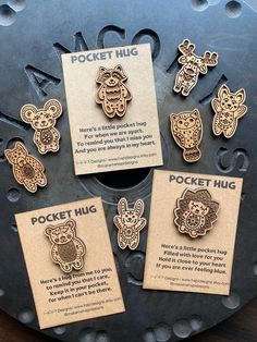 there are six wooden badges on the back of a metal object that says pocket hug