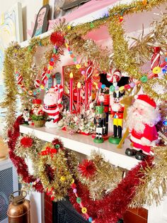 christmas decorations on a mantel with santa clause