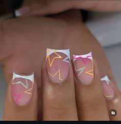 a woman's hand with pink and white nail designs on it, including arrows