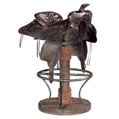 a metal bird feeder with two birds on it's top and one sitting on the base