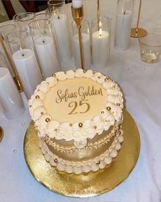 a white and gold cake sitting on top of a table