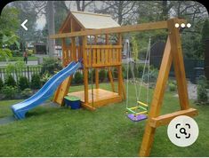 a wooden swing set with a blue slide