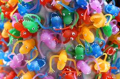 many colorful plastic toys are hanging on the wall