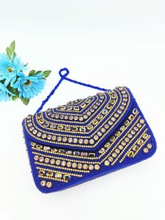 Handmade Blue Clutch Purse, Beaded Clutch Purse, Party Golden Purse, Blue Clutch, Glass Beaded Bag, Blue Beaded Handbag, Blue Box Bag, Blue Crossbody Bag The purse clutch is handmade and adorned with rhinestones and bead embroidery. This purse is stylish, flashy, and has a dazzled look. These purses/bags are for wedding functions, parties, and formal events, or you can use them as casual. These are fancy small bags ideal for money, cards, and makeup touchup kits. The bag has a single compartment Festive Beaded Rectangular Shoulder Bag, Festive Rectangular Beaded Evening Bag, Traditional Embellished Bags For Events, Hand Embellished Pouch Bag For Party, Bohemian Beaded Bags For Celebration, Festive Beaded Rectangular Evening Bag, Bohemian Rectangular Evening Bag For Party, Traditional Embellished Shoulder Bag For Party, Beaded Clutch Bag For Events