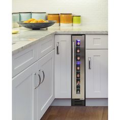 a wine cooler in the middle of a kitchen