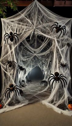 an outdoor halloween decoration with spider webs and pumpkins