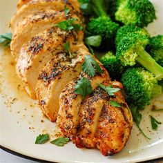 a white plate topped with chicken and broccoli