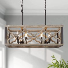 a wooden light fixture hanging from a ceiling