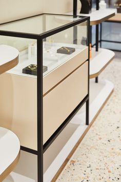 a display case with several items on it in a room filled with tables and chairs