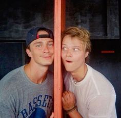 two young men are posing for a photo