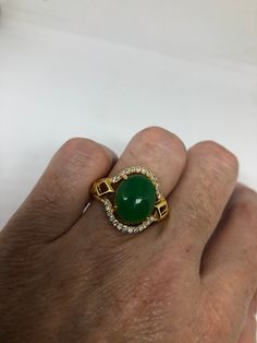 Vintage Lucky Green Nephrite Jade Golden ring Large green nephrite jade Gold finished German Silver Vintage ring, does not tarnish, NOT sterling Size 7, 8, or 9 All rings are shipped free in the US in a nice gift box. Check out our over a THOUSAND great reviews Engraving is $4 per letter and is not always perfect depending on the piece. It can take a few days if the jeweler is busy. This is payable to Paypal Judithsltd@gmail.com Green Cabochon Emerald Ring For Anniversary, Green Oval Cabochon Emerald Ring Collectible, Green Emerald Cabochon Ring For Anniversary, Collectible Jade Gemstone Rings, Green Cabochon Ring For Anniversary, Green Oval Cabochon Ring For Anniversary, Collectible Round Green Emerald Ring, Lucky Green, Ringe Gold