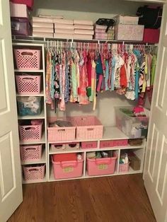 an organized closet with pink bins and baskets