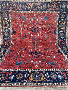 an antique persian rug with blue and red colors