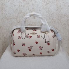 Coach Ladybug Floral Print Rowan Satchel (Cu272) Chalk Coated Canvas With Floral Ladybug Print. Chalk Leather Accents, Handles, And Strap. Zip Closure. Interior Zip And Slip Pockets. Exterior Zip Pocket. Handles With 4.5" Drop. 23" Adjustable Shoulder Strap. Gold Hardware. 10.5" (L) X 6.25" (H). Ladybug Print, Victoria Secret Perfume, Bags Coach, Phone Holster, Leather Accents, Signature Canvas, Walker Boots, Garment Bags, Hand Bags