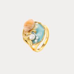 Bring the captivating beauty of the sea to your fingertips with the Ocean Shell Ring. Designed with lustrous gold-plated metal, this exquisite ring features an intricate shell-inspired design that evokes the natural wonder of a coastal retreat. Delicate yet bold, this enchanting accessory lends an air of stylish glamour, effortlessly elevating any outfit with its alluring oceanic inspiration. DETAILS Plating: 18K Gold Materials: 18K Gold on Brass, Dripping Oil, Pearl Diameter: 0.71"(1.8cm)   UK( Gold Ocean-inspired Rings For Beach, Elegant Shell-shaped Gold Rings, Elegant Gold Shell-shaped Rings, Ocean-inspired Shell-shaped Rings As Gift, Elegant Shell-shaped Ring For Gifts, Gold Shell-shaped Gift Ring, Gold Shell-shaped Ring For Gift, Gold Ocean Jewelry, Gold Enamel Open Ring For Wedding