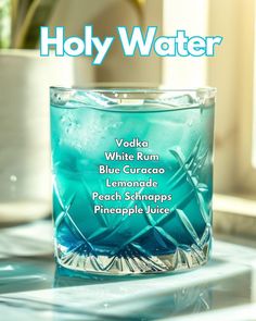 a glass filled with blue liquid sitting on top of a counter