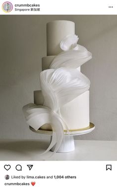 a three tiered cake with white icing on top