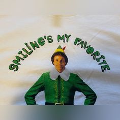 a white shirt with an image of the elf on it