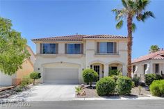 a house with palm trees in front of it and two garages on the other side