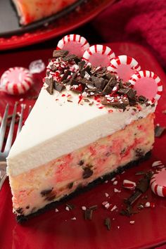 a slice of peppermint ice cream cake on a red plate with candy canes