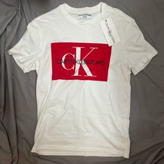 Size S New With Tags Calvin Klein Crew Neck T-shirt For Spring, Calvin Klein Logo Cotton Tops, Calvin Klein Cotton Logo Tops, Calvin Klein Cotton Tops With Logo, Spring Red T-shirt With Logo Print, Calvin Klein White Logo Print T-shirt, Calvin Klein Graphic Tee Short Sleeve T-shirt, Calvin Klein Graphic Tee Short Sleeve, Calvin Klein Graphic Tee With Short Sleeves