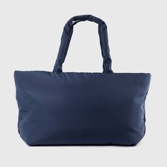 Holiday Essential Tote by Urban Originals is a chic, sustainable bag with a woven front made from recycled nylon. This versatile tote features multiple compartments and practical pockets, making it perfect for everyday use or a weekend getaway. Effortlessly combining style and functionality, elevate your look with this eco-friendly essential. Navy Nylon Bags For On-the-go, Sporty Packable Bags For On-the-go, Sporty Packable Travel Bags, Functional Shoulder Bag For Weekend, Weekend Nylon Bag With Zipper Closure, Rectangular Nylon Weekender Bag With Pockets, Functional Weekend Bags With Zipper Closure, Modern Packable Tote Bag, Navy Nylon Functional Shoulder Bag