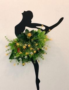 there is a flower arrangement in the shape of a female tennis player