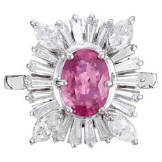 1950's pink sapphire and diamond engagement ring. GIA certified 1.50ct oval pink sapphire center stone set in 14k white gold with a halo of tapered baguette and marquise diamonds. GIA certified natural corundum, simple heat only, no other enhancements. 1 oval pink Sapphire, approx. total weight 1.50cts, SI1, 7.85 x 5.60 x 3.45 mm, natural corundum, simple heat only, GIA certificate # 2155946040 4 Marquise diamonds, approx. total weight .38 cts, F, VS 18 tapered baguette diamonds, approx. total w Gia Certified Oval Pink Ruby Ring, Gia Certified Oval Pink Diamond Ring, Oval Pink Gia Certified Diamond Ring, Pink Ruby Ring With Platinum, Gia Certified Pink Platinum Rings, Formal Pink Sapphire Ring In Platinum, Classic Pink Gia Certified Diamond Ring, Gia Certified Pink Diamond Ruby Ring, Pink Oval Diamond Ring In Platinum