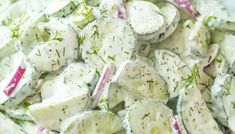 a salad with cucumber and dill on it is shown in a bowl