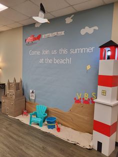 the children's playroom is decorated with cardboard boats, sandcastles and lighthouses