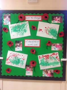 a green bulletin board with red poppies on it and the words lost we forget