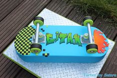 a skateboard cake is decorated with graffiti