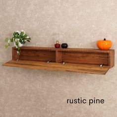 a wooden shelf with two bottles on it and a vase filled with flowers next to it