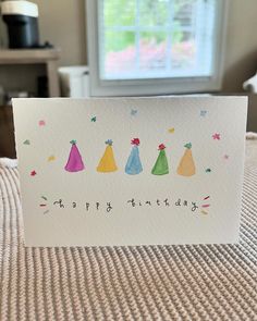 a happy birthday card with five party hats on it