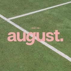 the words august are written in pink and white on a green grass field with a tennis racket