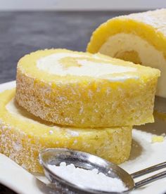 lemon cake roll on a plate with a spoon