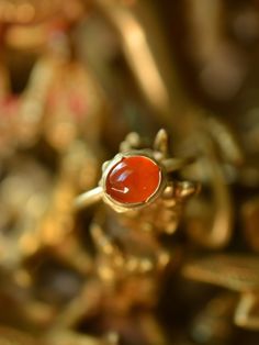 The fiery orange-red colour of this incredible and aptly named Mexican Fire Opal is reminiscent of glowing embers. I love the intensely saturated natural colour of this stone and the luminescent depth within it. One of a kind, this ring features a hand-forged 18k solid gold ring shank and a buttery 22k yellow gold bezel. Materials: Mexican Fire Opal, 18k and 22k yellow gold Size 7.5 Send me a direct email at hello@lorifrancescutti.com with any questions about this or another piece. Fiery Ring, Red Gemstone Ring For Ceremonial Occasions, Red Oval Jewelry For Ceremonial Occasion, Red Gemstone Rings For Ceremonial Occasion, Untreated Red Rings As A Gift, Untreated Red Rings For Gift, Red Untreated Rings As A Gift, Hand Forged Red Jewelry As A Gift, Red Carnelian Wedding Jewelry